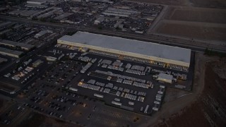 7.6K aerial stock footage approaching and passing a large warehouse building in Pacoima, California at twilight Aerial Stock Footage | AX0162_119