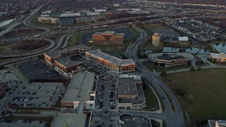 4K aerial stock footage of approaching and flying past a shopping mall at sunset in Burr Ridge, Illinois Aerial Stock Footage | AX0163_0011