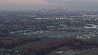 4K aerial stock footage tilt from homes to reveal Chicago skyline at sunset in Forest View, Illinois Aerial Stock Footage | AX0163_0017