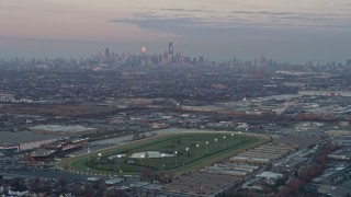 4K aerial stock footage of approaching the Chicago skyline at sunset from a racetrack in Stickney, Illinois Aerial Stock Footage | AX0163_0018