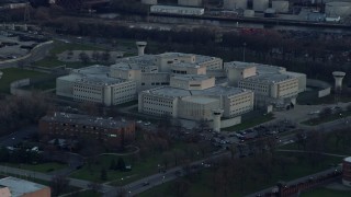 4K aerial stock footage of flying by the Cook County Jail at sunset in West Side Chicago, Illinois Aerial Stock Footage | AX0163_0022