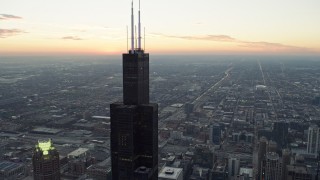 4K aerial stock footage of orbiting the top of Willis Tower at twilight, Downtown Chicago, Illinois Aerial Stock Footage | AX0163_0040