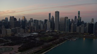 4K aerial stock footage approach skyscrapers bordering Grant Park at twilight, Downtown Chicago, Illinois Aerial Stock Footage | AX0163_0048