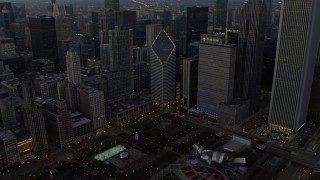 4K aerial stock footage approach skyscraper, tilt to Grant Park monuments at twilight, Downtown Chicago, Illinois Aerial Stock Footage | AX0163_0050