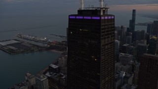 4K aerial stock footage orbit John Hancock Center at twilight in Downtown Chicago, Illinois Aerial Stock Footage | AX0163_0054