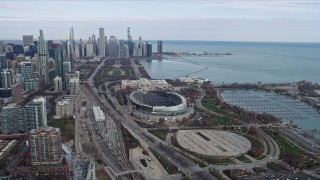 4K aerial stock footage of flying by Soldier Field football stadium, reveal Downtown Chicago skyline, Illinois Aerial Stock Footage | AX0165_0061