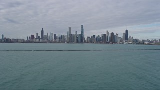 AX0165_0070 - 4K aerial stock footage of the Downtown Chicago skyline seen from Lake Michigan breakwater, Illinois