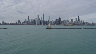 4K aerial stock footage fly over lighthouse to approach the Downtown Chicago skyline, Illinois Aerial Stock Footage | AX0165_0071