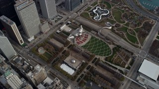 AX0165_0077 - 4K aerial stock footage of the Cloud Gate sculpture, ice skating rink, Jay Pritzker Pavillion at Grant Park, Downtown Chicago, Illinois