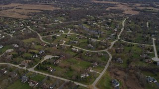 AX0166_0034 - 4K aerial stock footage of flying by peaceful suburban neighborhoods in Lake Zurich, Illinois