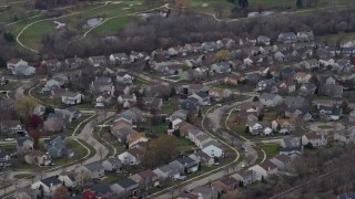 AX0166_0040 - 4K aerial stock footage of passing by a suburban neighborhood in Round Lake Beach, Illinois