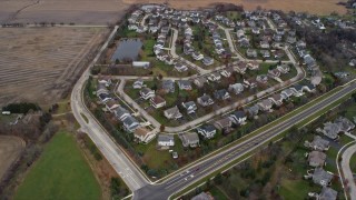 AX0166_0043 - 4K aerial stock footage of tract homes near Hendrick Lake in Lindenhurst, Illinois