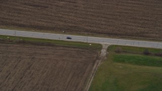 4K aerial stock footage of a car traveling on a country road in Bristol, Wisconsin Aerial Stock Footage | AX0166_0047