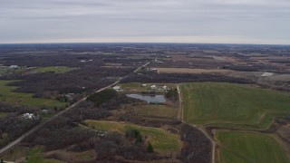 4K aerial stock footage of flying over farms and fields in Bristol, Wisconsin Aerial Stock Footage | AX0166_0049