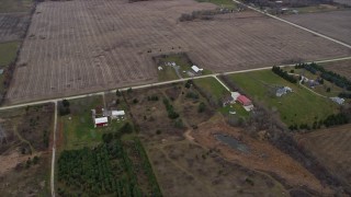 AX0166_0058 - 4K aerial stock footage of a red barn and farm fields in Franksville, Wisconsin