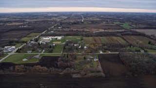 4K aerial stock footage of flying over farms and fields around an elementary school in Franksville, Wisconsin Aerial Stock Footage | AX0167_0039