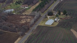 4K aerial stock footage of a car traveling a county road in Union Grove, Wisconsin Aerial Stock Footage | AX0167_0047