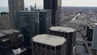 4K aerial stock footage of flying by skyscrapers toward Willis Tower in Downtown Chicago, Illinois Aerial Stock Footage | AX0167_0087