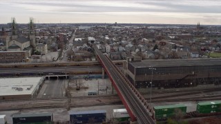 4K aerial stock footage ascend over train tracks to reveal urban neighborhood, West Side Chicago, Illinois Aerial Stock Footage | AX0168_0001