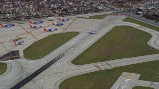 AX0168_0011 - 4K aerial stock footage a commercial jet racing down the runway at Chicago Midway International Airport, Illinois