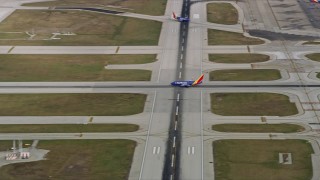 AX0168_0012 - 4K aerial stock footage a commercial jet lifting off from Chicago Midway International Airport, Illinois