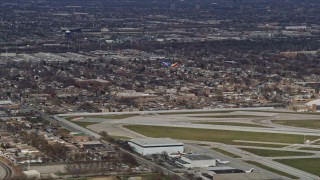 AX0168_0013 - 4K aerial stock footage a commercial jet just after lifting off from Chicago Midway International Airport, Illinois