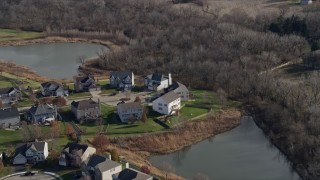 4K aerial stock footage of flying away from waterfront homes in Lockport, Illinois Aerial Stock Footage | AX0168_0031