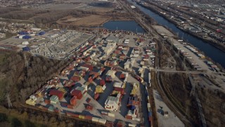 AX0169_0015 - 4K aerial stock footage of flying over storage tanks and shipping containers, Forest View, Illinois