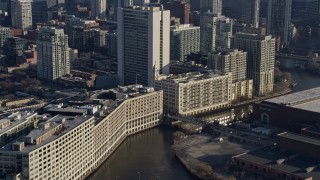 4K aerial stock footage of the Chicago River between office buildings in Downtown Chicago, Illinois Aerial Stock Footage | AX0169_0026