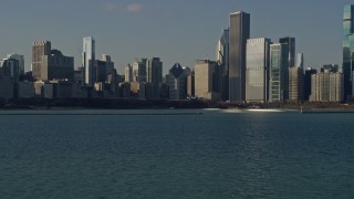 4K aerial stock footage of flying low toward Grant Park and towering skyscrapers, Downtown Chicago, Illinois Aerial Stock Footage | AX0169_0038