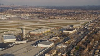 AX0169_0107 - 4K aerial stock footage of a commercial plane on the runway at Chicago Midway International Airport at sunset, Illinois