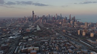 4K aerial stock footage wide view of the Downtown Chicago skyline seen from South Side Chicago neighborhoods at sunset, Illinois Aerial Stock Footage | AX0170_0010