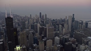 4K aerial stock footage of flying past downtown's tall skyscrapers at sunset, Downtown Chicago, Illinois Aerial Stock Footage | AX0170_0034