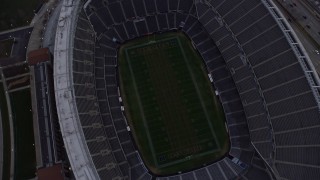 4K aerial stock footage of a bird's eye view of Soldier Field football stadium at sunset, Chicago, Illinois Aerial Stock Footage | AX0170_0038