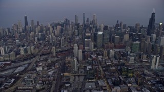 4K aerial stock footage of flying high toward skyscrapers in downtown at sunset, Downtown Chicago, Illinois Aerial Stock Footage | AX0170_0046