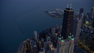 4K aerial stock footage orbit John Hancock Center with holiday lights at twilight, Downtown Chicago, Illinois Aerial Stock Footage | AX0170_0054