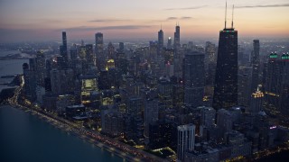 4K aerial stock footage of John Hancock Center with holiday lights at twilight, Downtown Chicago, Illinois Aerial Stock Footage | AX0170_0055