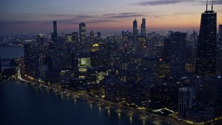 4K aerial stock footage of lakeside skyscrapers seen from Lake Michigan at twilight, Downtown Chicago, Illinois Aerial Stock Footage | AX0170_0060