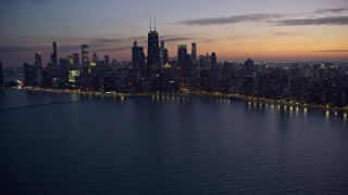 4K aerial stock footage of John Hancock Center and lakeside skyscrapers seen from Lake Michigan at twilight, Downtown Chicago, Illinois Aerial Stock Footage | AX0170_0061