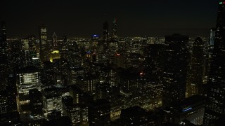 4K aerial stock footage tilt from the lake and ascend over downtown skyscrapers at night, Downtown Chicago, Illinois Aerial Stock Footage | AX0170_0093