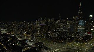 4K aerial stock footage of downtown skyscrapers seen from West Side at night, Downtown Chicago, Illinois Aerial Stock Footage | AX0170_0101