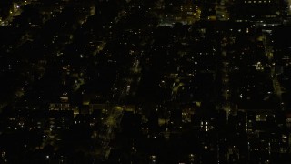 4K aerial stock footage of flying past urban neighborhoods on the West Side at night, Chicago, Illinois Aerial Stock Footage | AX0170_0103