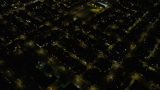 AX0170_0104 - 4K aerial stock footage of a bird's eye view of urban neighborhoods on the West Side at night, Chicago, Illinois