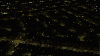 4K aerial stock footage of passing urban neighborhoods on the Northwest Side at night, Chicago, Illinois Aerial Stock Footage | AX0170_0107