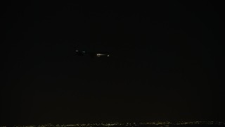 4K aerial stock footage of tracking a commercial jet over the Northwest Side at night, Chicago, Illinois Aerial Stock Footage | AX0170_0110