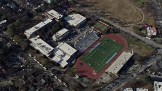 AX0171_0046 - 6.7K aerial stock footage of flying by a high school and football field in Atlanta, Georgia