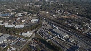 6.7K aerial stock footage fly over apartment buildings by train yard to reveal warehouse buildings in Decatur, Georgia Aerial Stock Footage | AX0171_0129