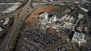 AX0171_0135 - 6.7K aerial stock footage approach a hospital in Lawrenceville, Georgia, and tilt to a bird's eye view