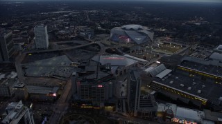 AX0171_0191 - 6.7K aerial stock footage orbit arena, CNN Center, and stadium at sunset in Atlanta, Georgia