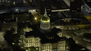 AX0171_0206 - 6.7K aerial stock footage of flying away from the Georgia State Capitol Building at night in Downtown Atlanta, Georgia